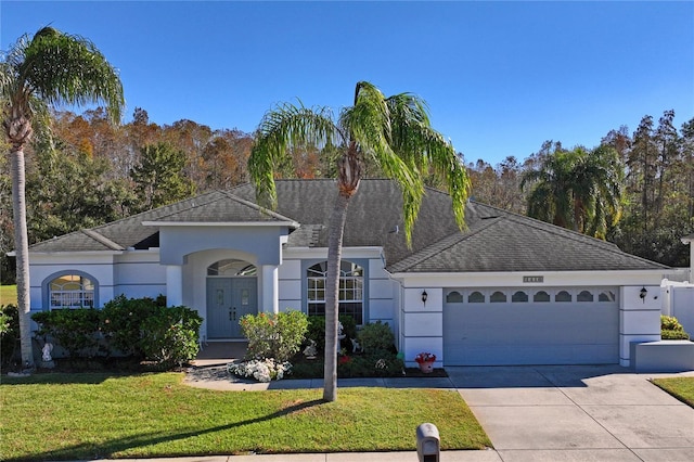 view of front of property featuring a front yard and a garage