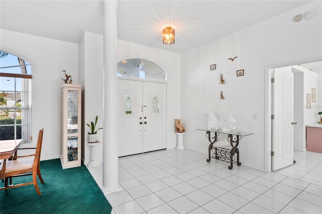 tiled entrance foyer with decorative columns