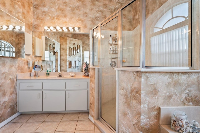 bathroom with tile patterned flooring, vanity, and a shower with shower door