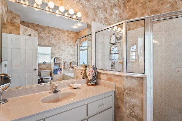 bathroom featuring vanity, an enclosed shower, and toilet