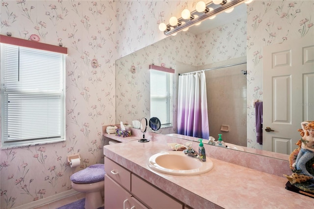 bathroom with tile patterned flooring, vanity, toilet, and walk in shower