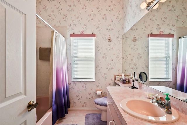 full bathroom with tile patterned floors, vanity, shower / bath combo with shower curtain, toilet, and plenty of natural light