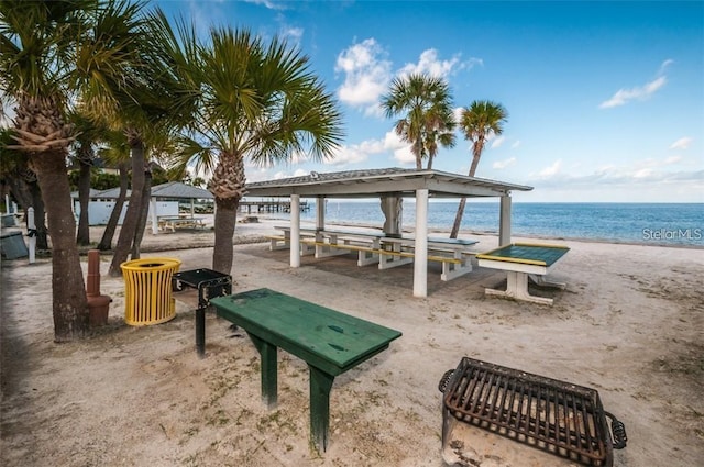 view of home's community featuring a water view and a beach view