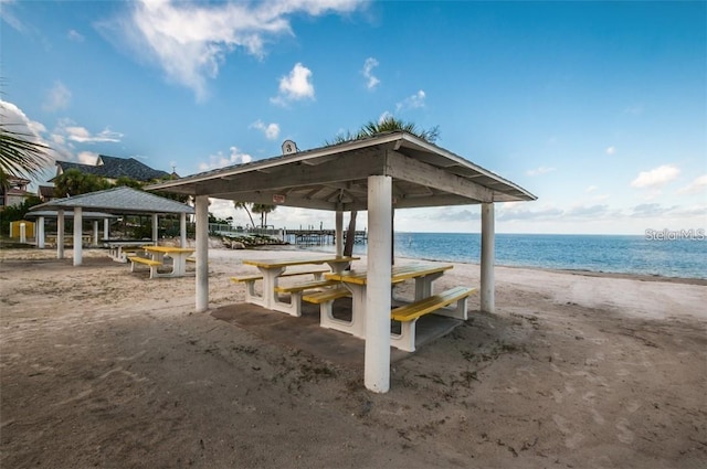 view of home's community with a gazebo, a view of the beach, and a water view