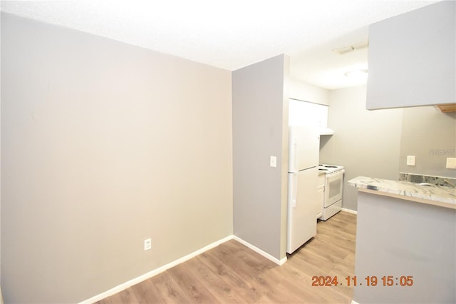 kitchen featuring white appliances and light wood-type flooring