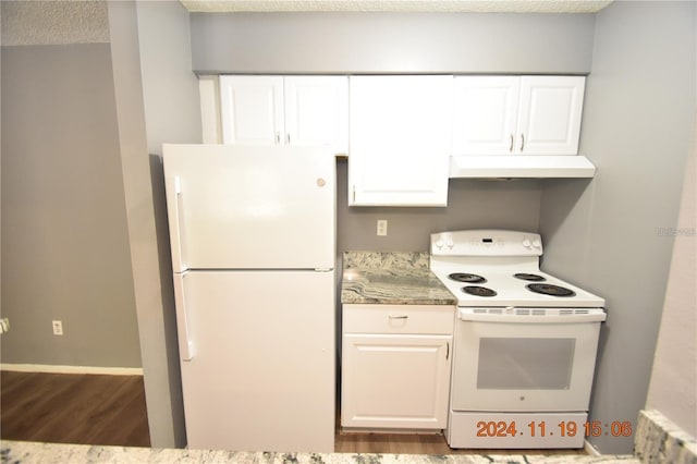 kitchen with a textured ceiling, white cabinetry, wood-type flooring, and white appliances