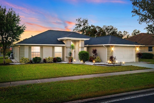 view of front facade with a lawn and a garage