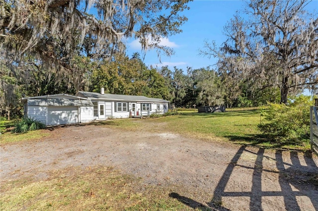 ranch-style house with a garage and a front yard