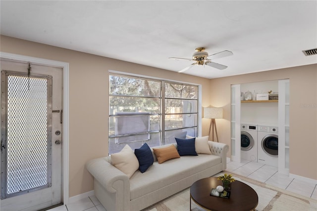 tiled living room with ceiling fan and independent washer and dryer