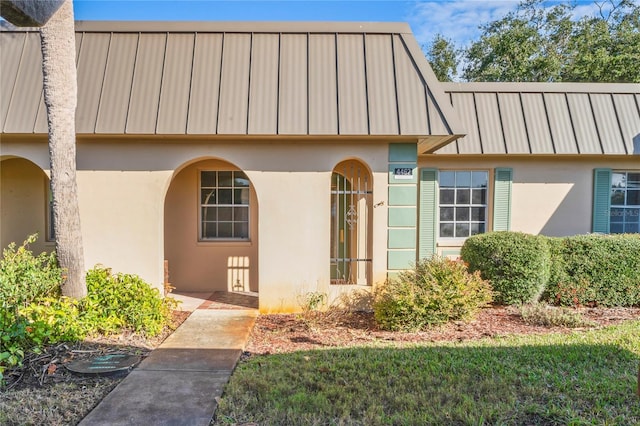 doorway to property with a yard