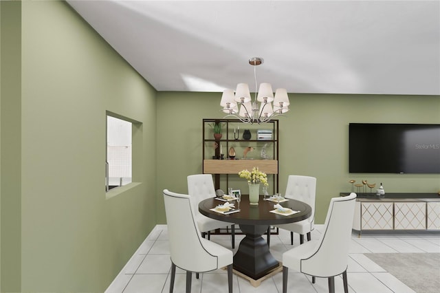 dining room featuring light tile patterned floors and an inviting chandelier