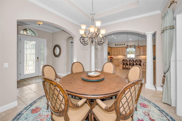 dining area featuring light tile patterned floors, a tray ceiling, crown molding, and an inviting chandelier