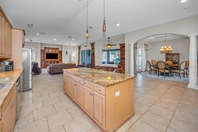 kitchen featuring stainless steel appliances, arched walkways, open floor plan, and decorative columns