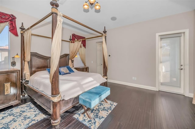 bedroom featuring wood finished floors and baseboards