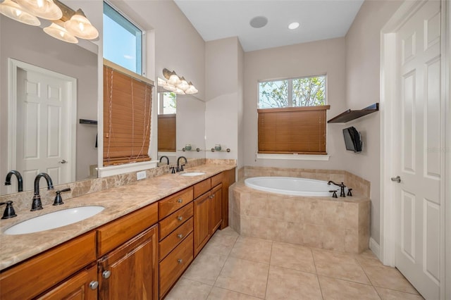 full bath with tile patterned flooring, double vanity, a sink, and a bath