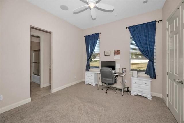 office with a ceiling fan, carpet flooring, and baseboards