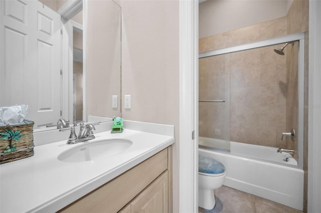 full bathroom with tile patterned flooring, bathing tub / shower combination, toilet, and vanity