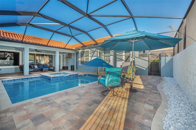 view of pool with a pool with connected hot tub, a lanai, a patio, and ceiling fan