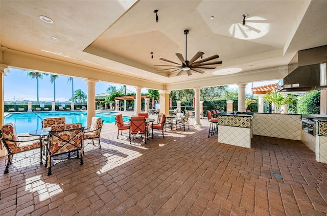 view of patio / terrace with ceiling fan and a community pool