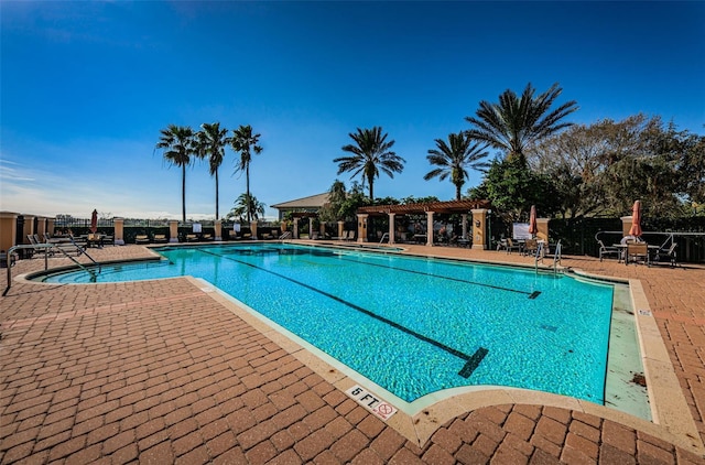 community pool featuring a patio area and fence