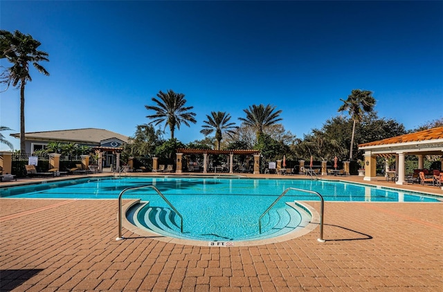 pool featuring a pergola and a patio