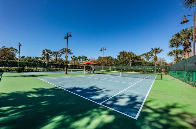 view of sport court with fence