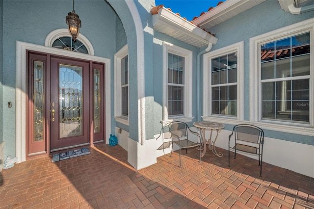 view of exterior entry with stucco siding