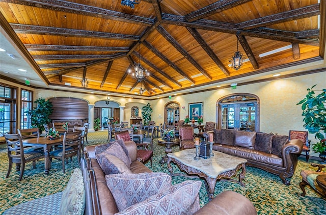 living area featuring a textured wall, wooden ceiling, plenty of natural light, and vaulted ceiling with beams