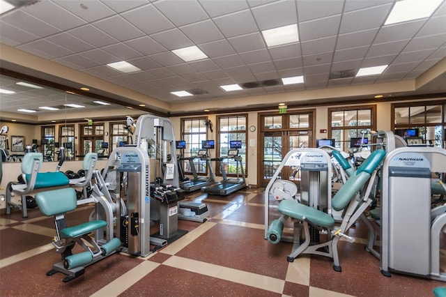 workout area featuring a drop ceiling and french doors