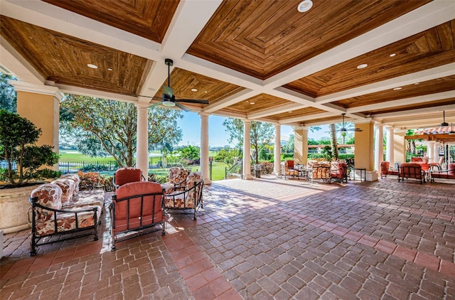 view of patio featuring ceiling fan, outdoor dining space, and fence