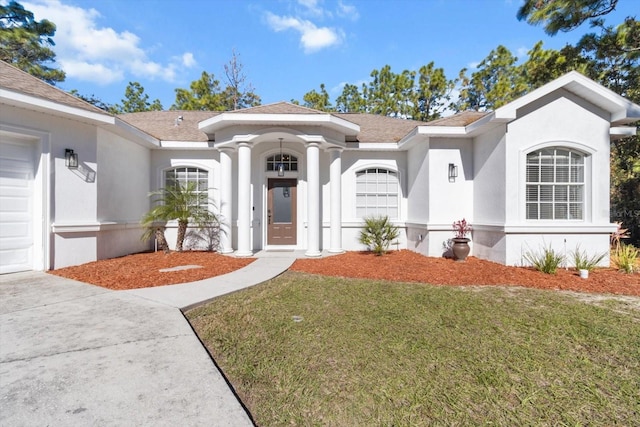 view of front of property with a front lawn and a garage