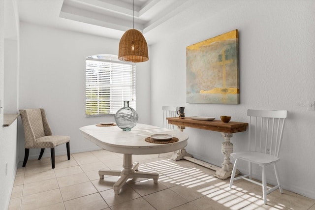 sitting room with light tile patterned floors and a tray ceiling