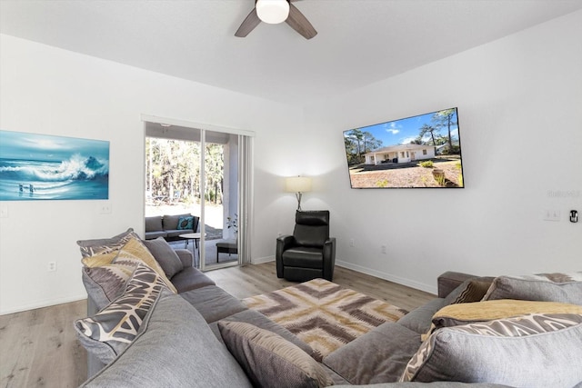 living room featuring ceiling fan and light hardwood / wood-style flooring