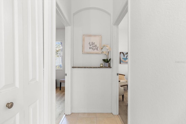 hall with light tile patterned floors