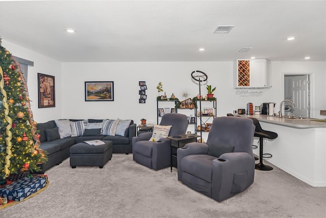 carpeted living room featuring sink