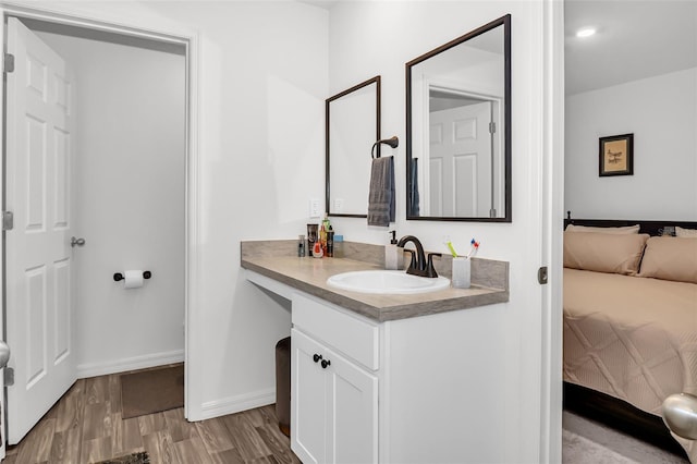 bathroom with hardwood / wood-style floors and vanity