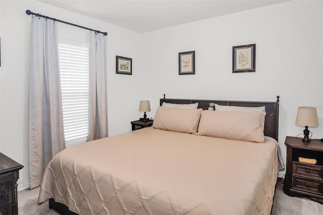 bedroom featuring light colored carpet