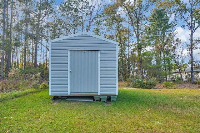 view of outbuilding with a lawn