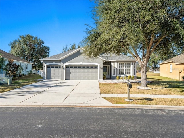 view of front of home featuring a front yard and a garage