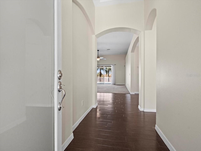 hallway with dark hardwood / wood-style flooring