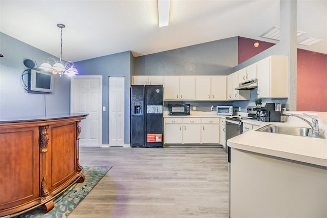 kitchen with pendant lighting, sink, lofted ceiling, and black appliances