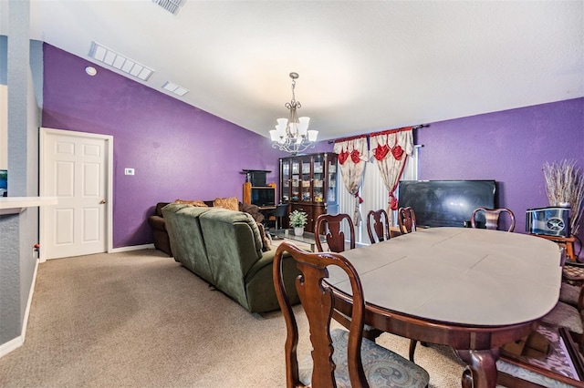 dining space featuring carpet flooring and a notable chandelier