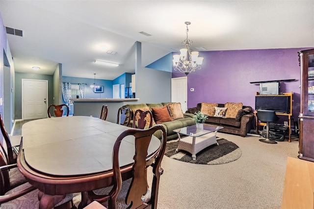 dining space with carpet floors, lofted ceiling, and an inviting chandelier