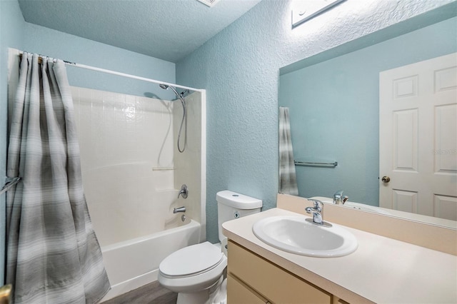 full bathroom with vanity, a textured ceiling, wood-type flooring, shower / bathtub combination with curtain, and toilet