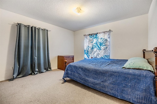 carpeted bedroom featuring a textured ceiling