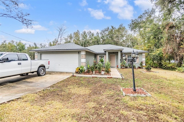 view of front of property featuring a garage and a front lawn