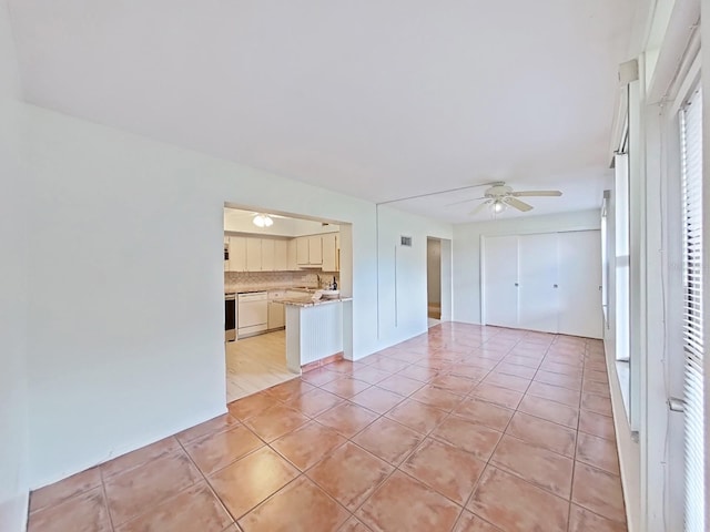 unfurnished living room with light tile patterned floors and ceiling fan