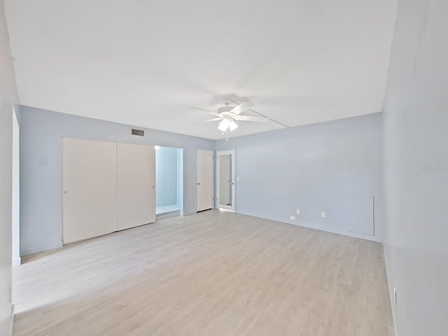 unfurnished room featuring ceiling fan and light wood-type flooring