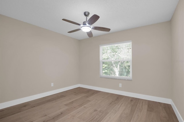 spare room featuring a textured ceiling and light wood-type flooring