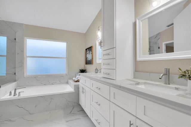 bathroom with vanity, separate shower and tub, and vaulted ceiling